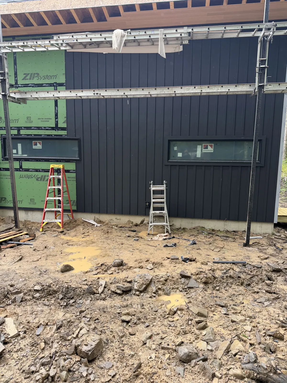 Dark vertical siding going up on a new construction home