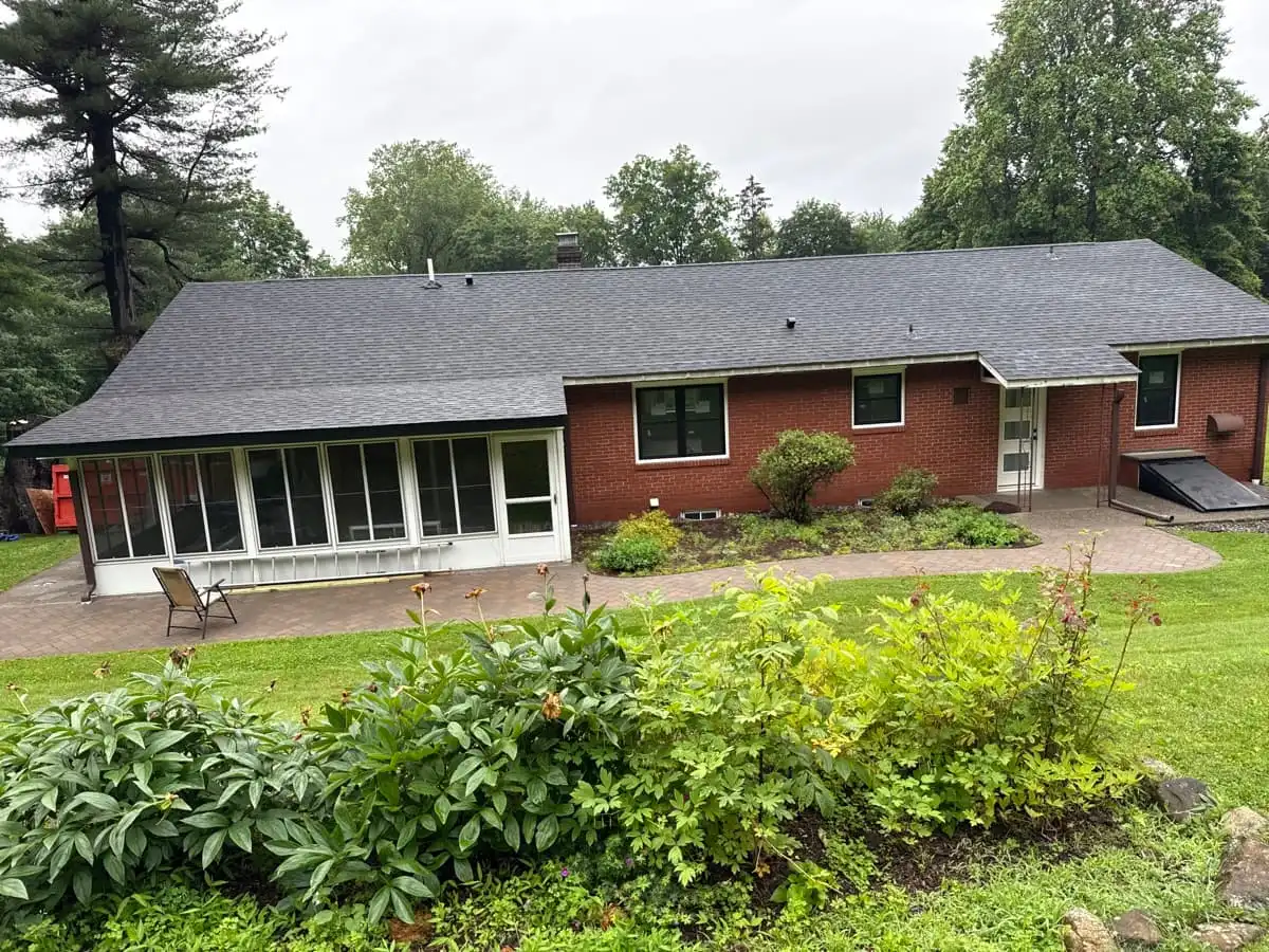 Completed asphalt shingle roof on a brick ranch home by SSKM Construction