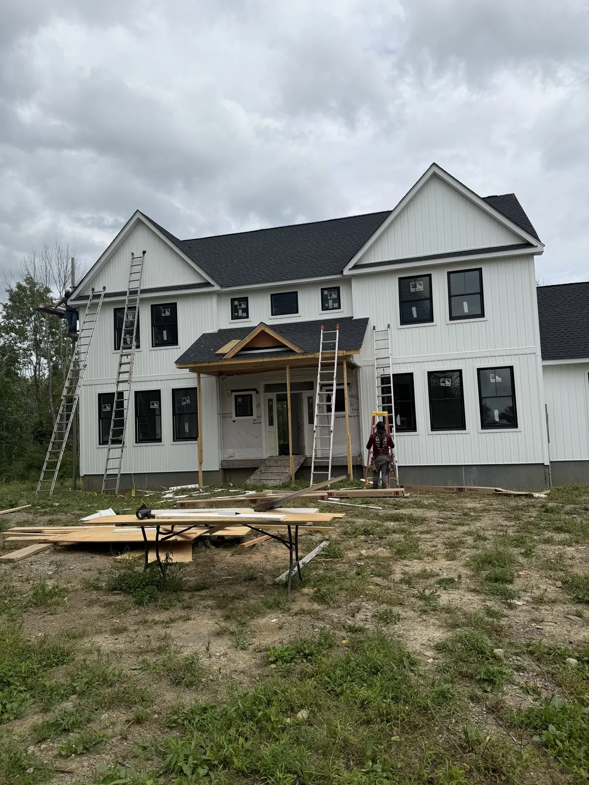 New construction two-story white home with black-framed windows