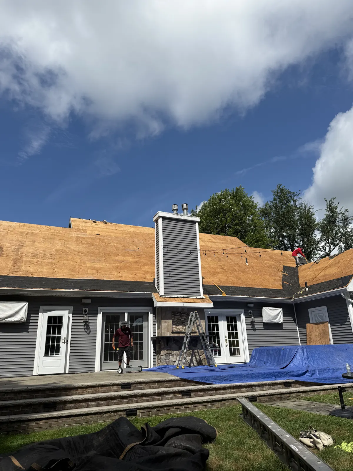 New plywood roof decking installed on a home with a chimney