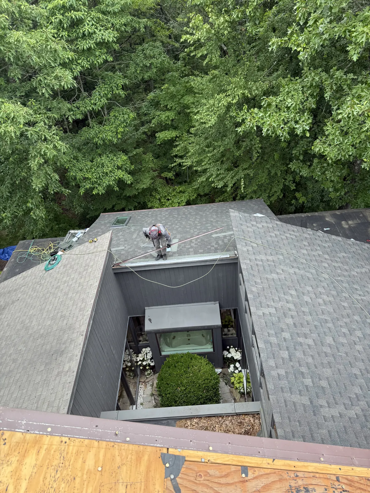 New shingle roof wrapped around a recessed courtyard