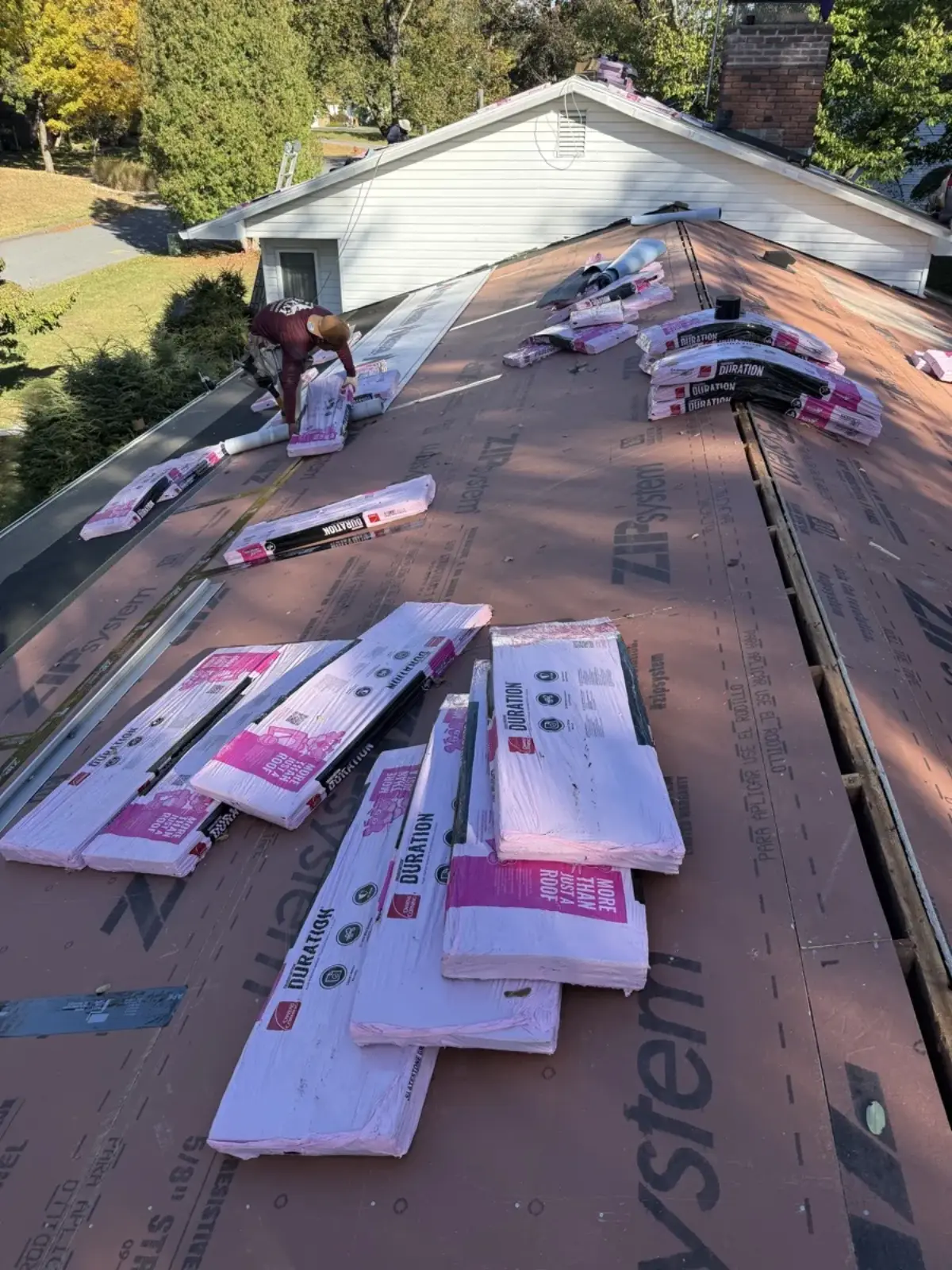 Owens Corning Duration shingle bundles staged on a roof deck