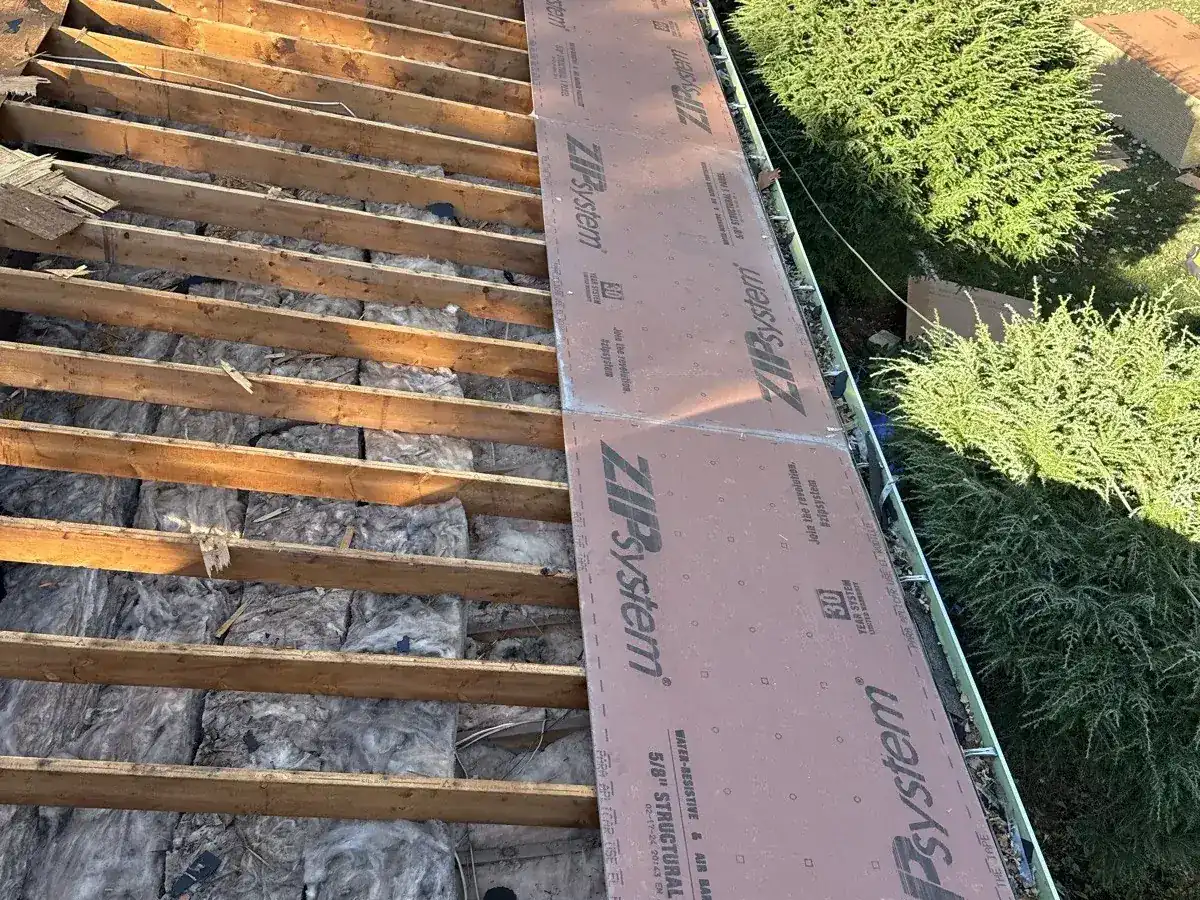New roof deck panels installed over the original rafters during a re-roof