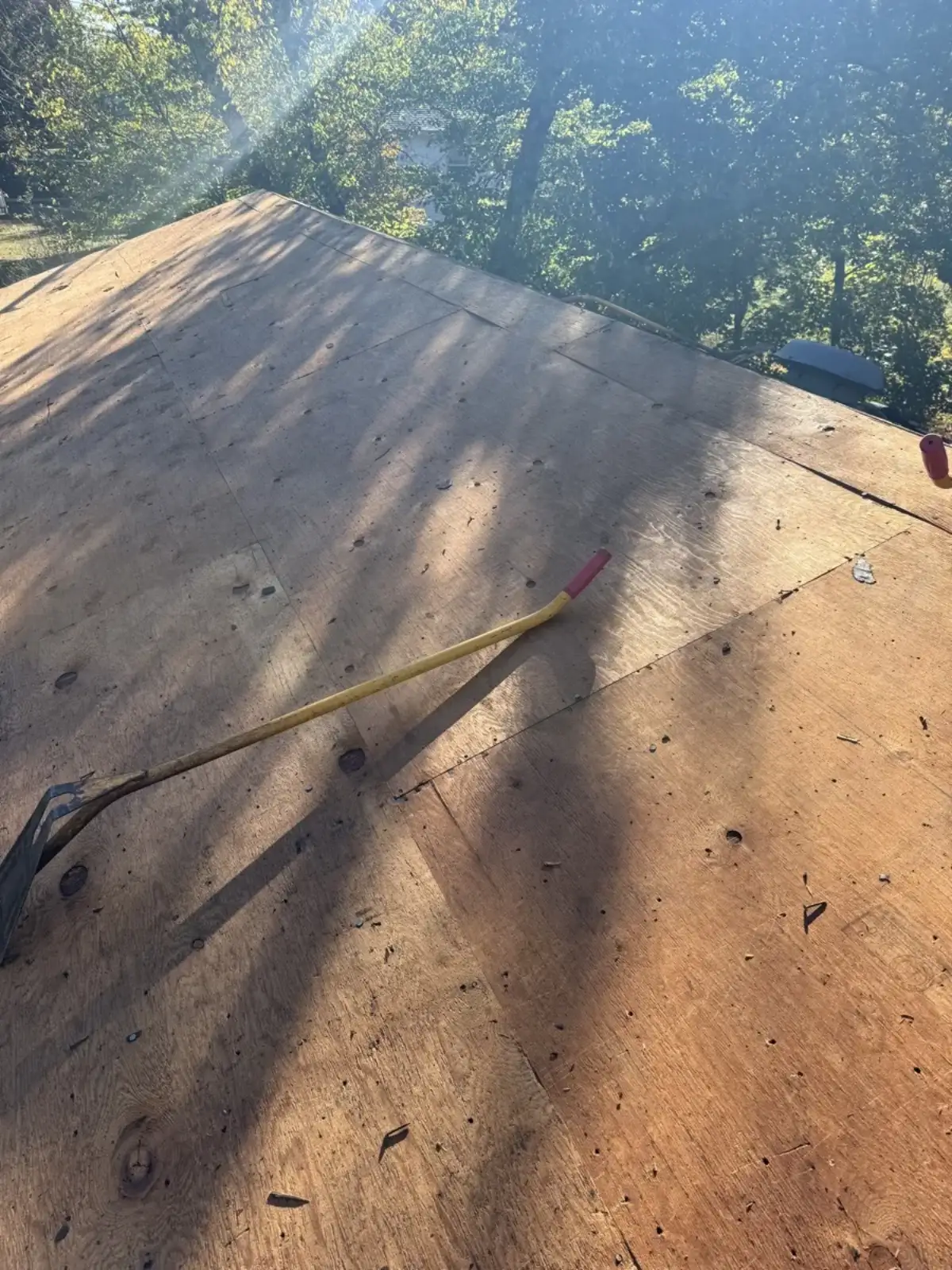 Pry bar on a roof deck during a shingle tear-off