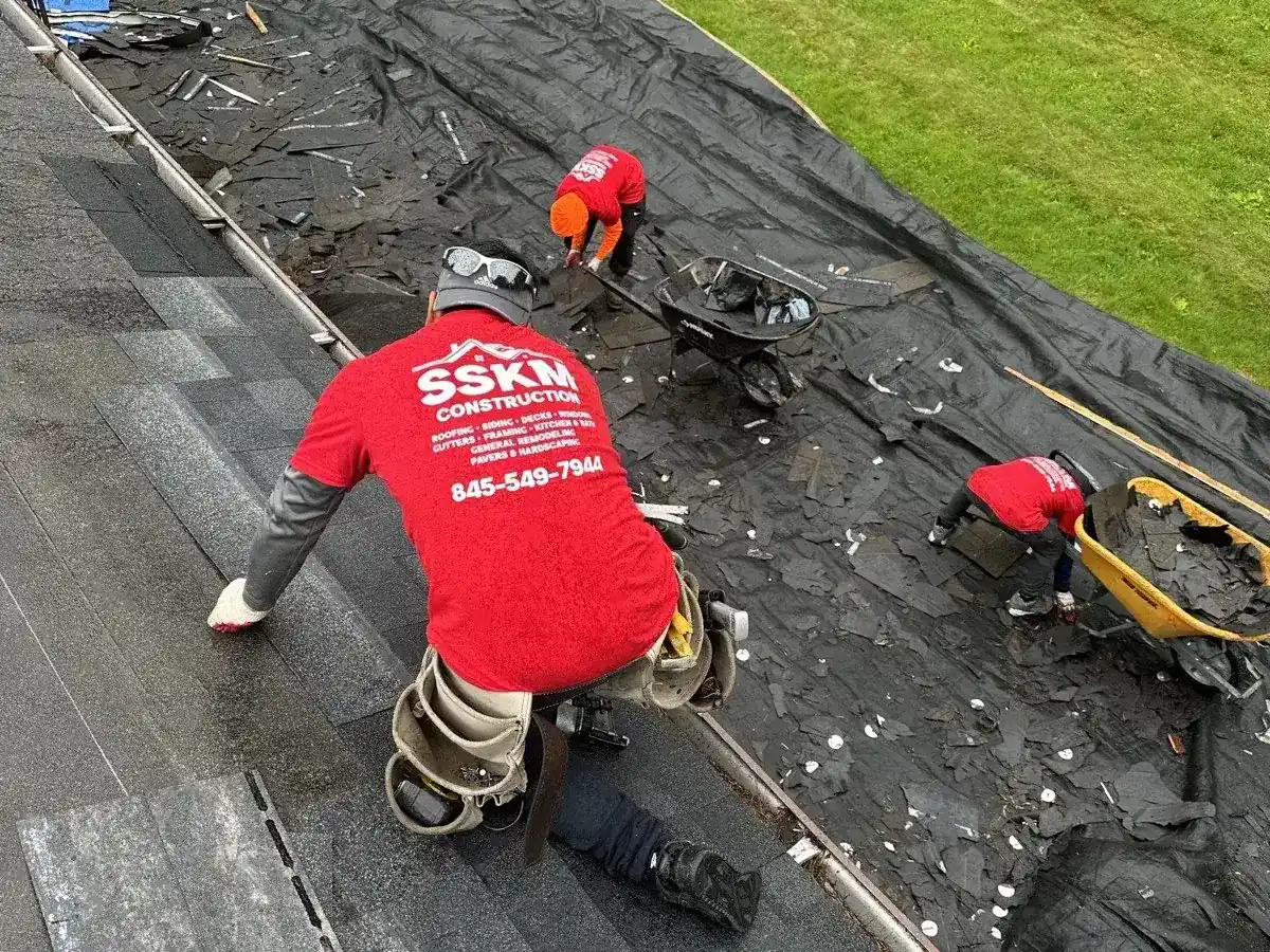 SSKM Construction crew member at work on a roof in Hughsonville, NY
