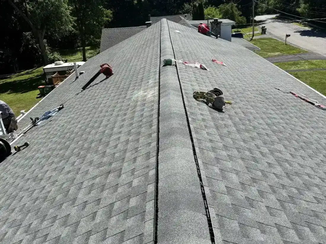Crew shingling a long roof line in Hyde Park, NY